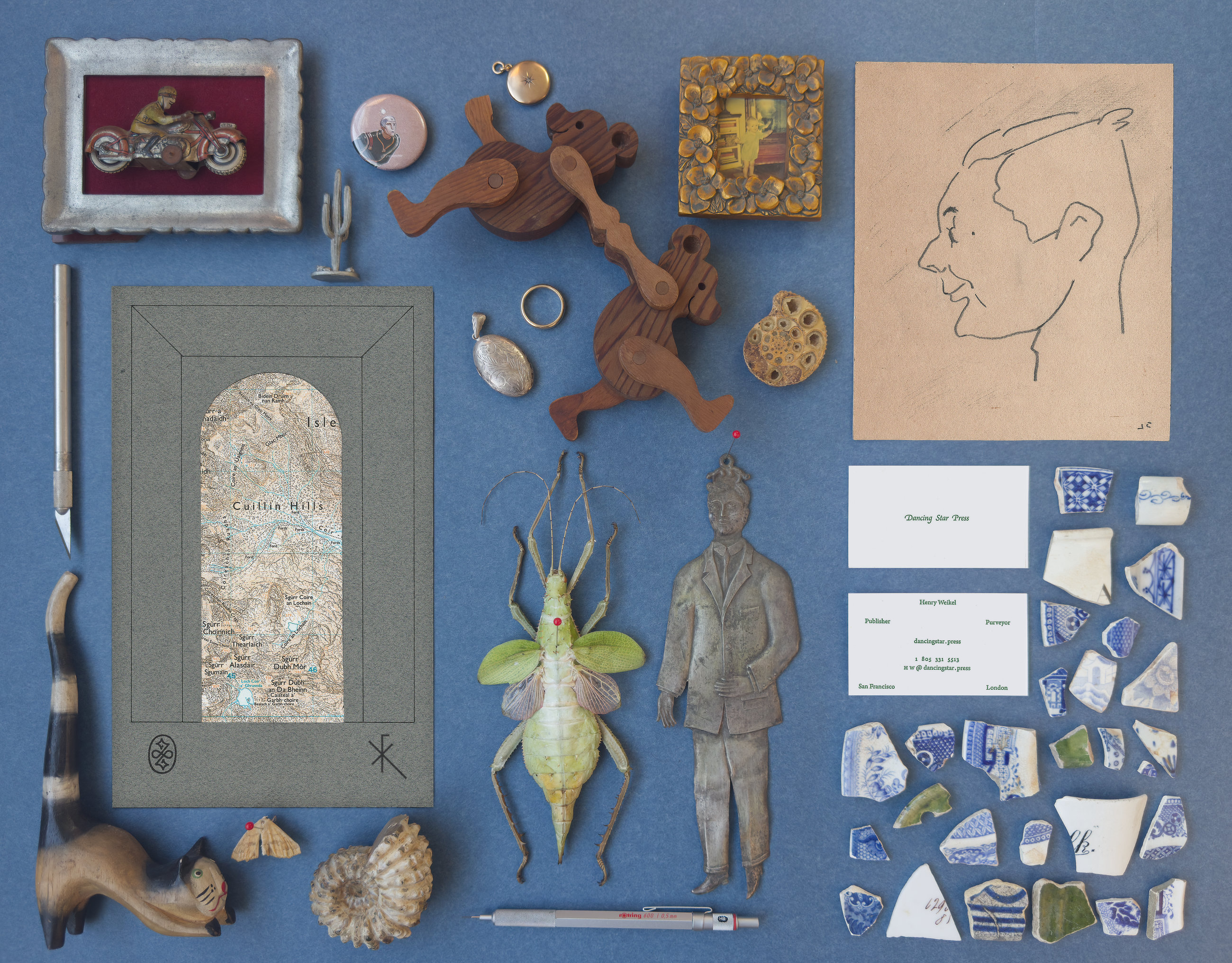 A cabinet of curiosities laid out on blue paper